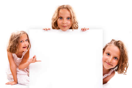 Smiling happy 7 years old girl look outs from the empty banner. Collage.の写真素材