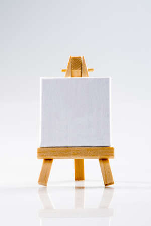 Little tripod wood easel with square white canvas.の写真素材
