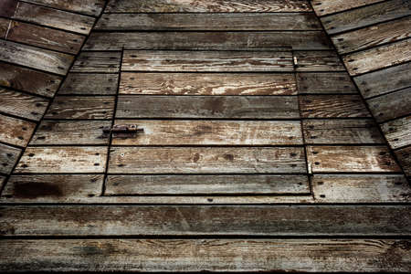 Grunge wooden door framed by planks a rusted close.の写真素材