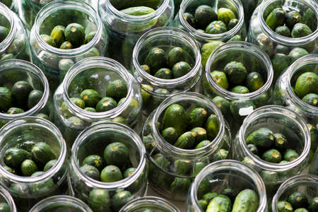 Top view of jars of fresh cucumbers ready to pickledの写真素材