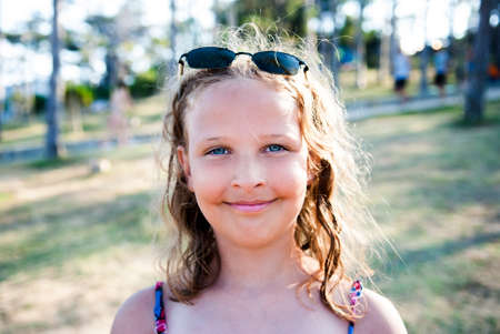 Summer portrait of young girl wearing sunglasses.の写真素材