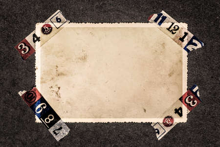 Blank old photo for a picture, with decorative torn tape corners from photo album page.の写真素材