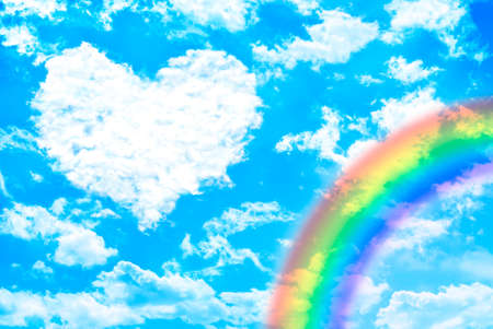 White clouds over blue sky forming âheartâ shape with rainbow. Valentine concept.の写真素材