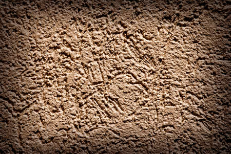 Grunge texture, rough ragged dark background, brown plaster stucco wall.の写真素材