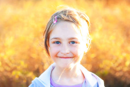 Summer girl portrait on yellow blurred sunset background meadow. Shallow Depth of Field. SDF.