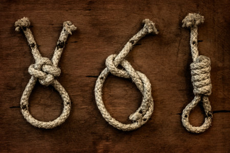 Vintage navy sailors binding knots on the wooden background.の写真素材