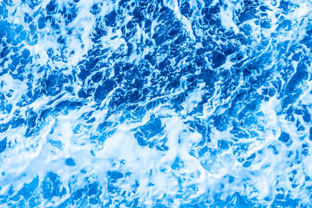 Aerial Ocean water blue surface with foam and waves.の写真素材