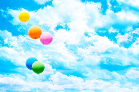 Five colorful air balloons over blue sky and white clouds.の写真素材