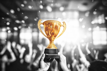 People Celebrating Gold Trophy Against Black and White Background. Concept of success and achievementの素材