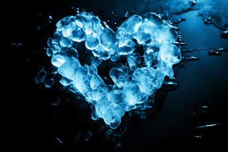 Blue Ice in the Shape of Heart Melting on Black Backgroundの素材