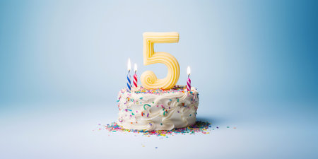 Number Five Shaped Birthday Cake with Lit Candle on Bright Blue Background Banner Copy Spaceの素材