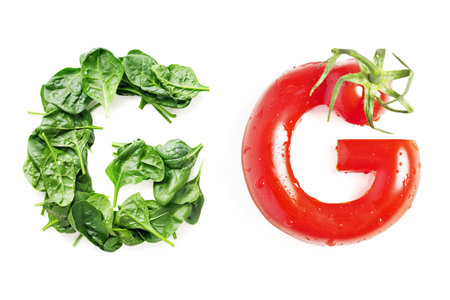 Vegetable Letter "G" Made of Spinach and Red Tomato Isolated on White Backgroundの素材