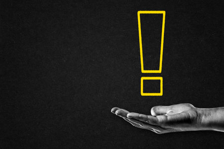 Yellow Exclamation Point on Hand in Black and White, Copy Space