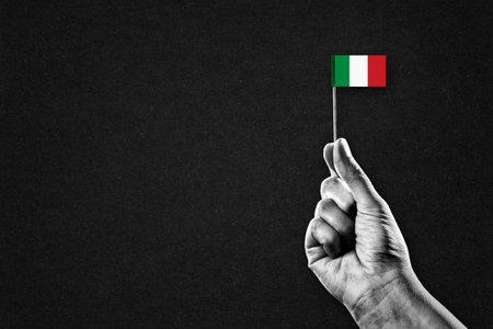 Hand in Black and White Holding Flag of Italy, Copy Spaceの写真素材