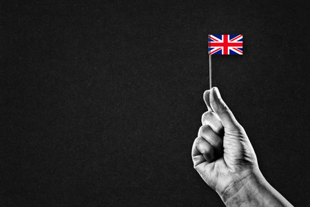 Hand in Black and White Holding Flag of UK, Copy Spaceの写真素材