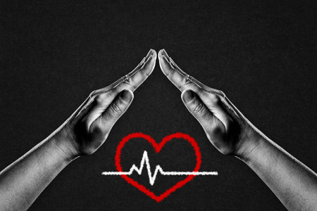 Hands in Black and White in Gesture of Protection Red Heart with Cardiogram Sign on Black Textured Background with Copy Spaceの写真素材