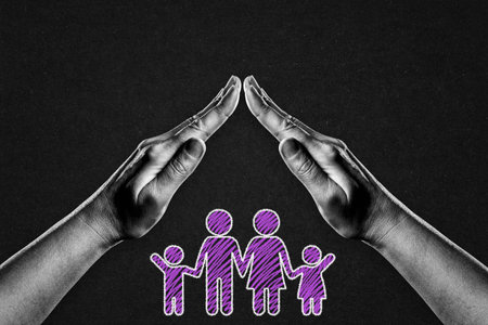Hands in Black and White in Gesture of Protection Family Symbol Sign on Black Textured Background with Copy Spaceの写真素材