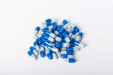Blue pills on white background