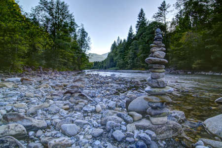 Mountain river in the morning with stone towers in the foreground の写真素材