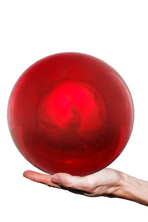 Large red ball is held on one hand, white background の写真素材
