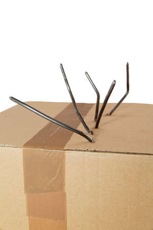 Box of damage caused by nails on white の写真素材