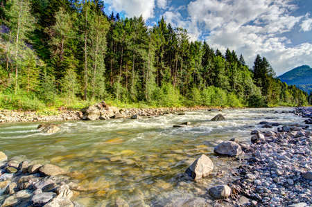 Mountain river in summer in the Alpsの写真素材