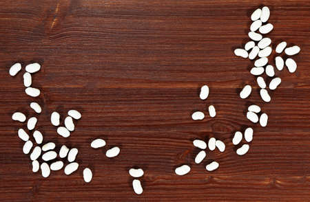 White beans on a dark cutting board, from above 