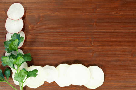 Food board with slices of radish as a frame 