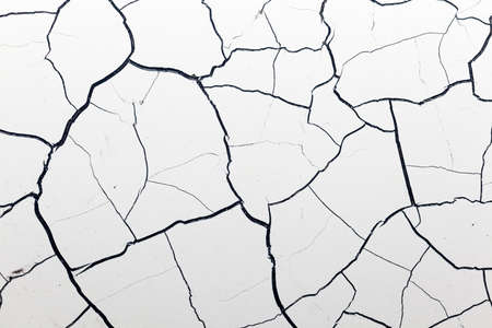 White face with black cracks on a surface.の写真素材