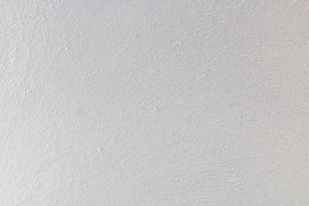 White rustic wall, painted with granules of sand.