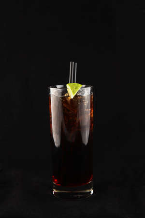 red hard liquer coctail with lime decorationの写真素材