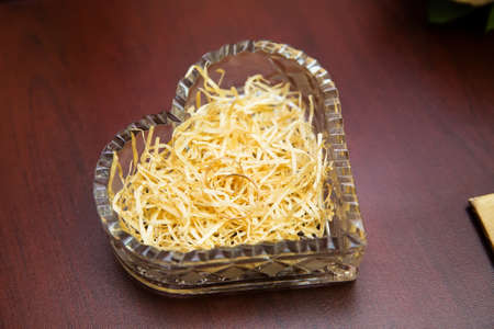 Gold wedding rings on the stand for ringsの写真素材