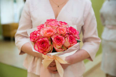 Beautiful wedding bouquet of flowers in bride's handsの写真素材