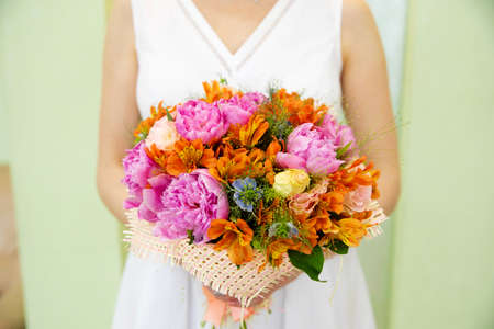 Wedding bouquet of flowers in the hands of the brideの写真素材