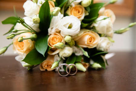 Gold wedding rings and bridal bouquetの写真素材