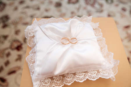 Gold wedding rings on stand for ringsの写真素材