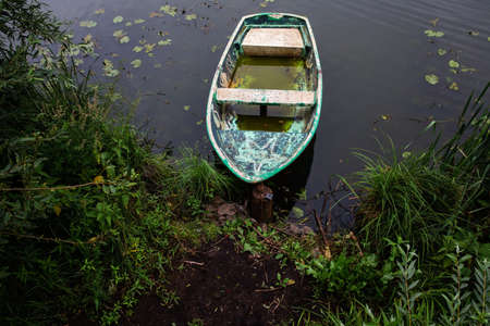 Wooden boat on the lake. Fishing boat