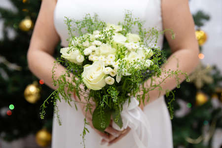 Beautiful wedding bouquet of flowers in the hands of the brideの写真素材