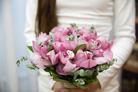 Beautiful wedding bouquet of flowers in the hands of the brideの写真素材