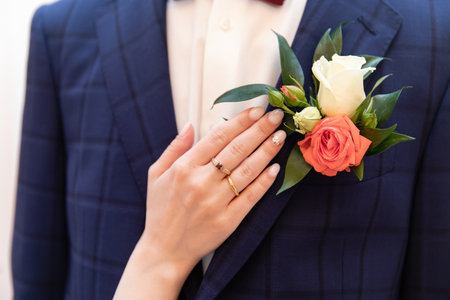 Bride's hand on his shoulder groomの写真素材