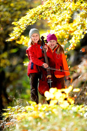 Young musicians autumn forestの写真素材