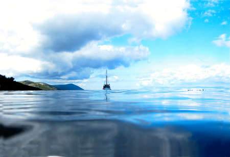 Ship Floating on Lake Under Sunny Blue Sky     の写真素材