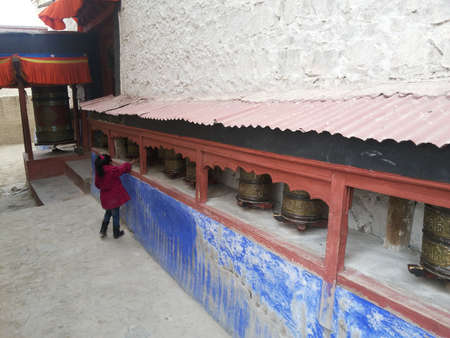 Buddhist Gompa with prayer wheels of different sizes. The beautiful designs of these wheels are not seen anywhere else.のeditorial素材