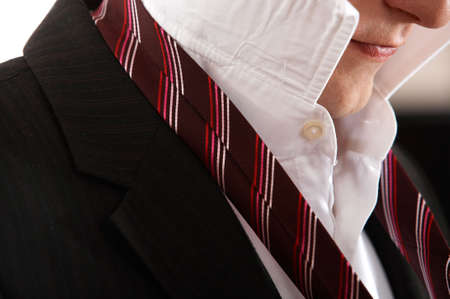 adult man is making a tie knot