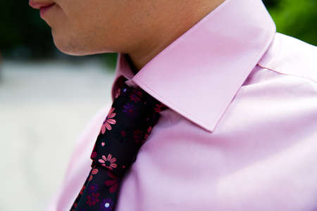 adult caucasian man is making a tie knotの写真素材