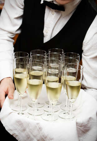 professional waiter in uniform is serving wineの写真素材