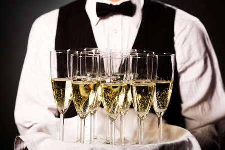 professional waiter in uniform is serving wineの写真素材