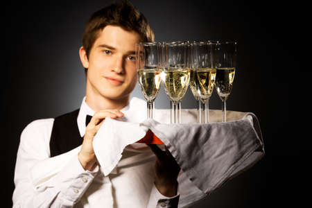 professional waiter in uniform is serving wineの写真素材