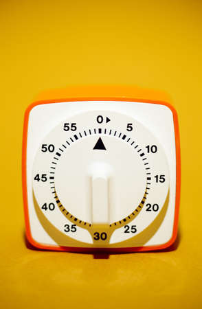 retro style disc kitchen timer over orange background