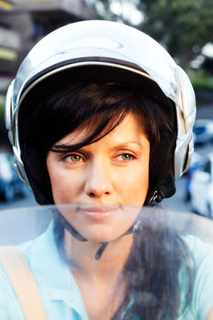 young caucasian woman is driving a bikeの写真素材